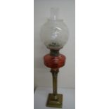 Brass Corinthian column oil lamp with red glass reservoir and etched shade (80cm high)