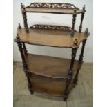 Victorian rosewood four tier whatnot with raised fretwork back (width 81cm)