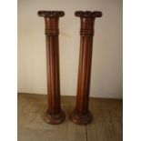 Pair of mahogany with crown tops and fluted columns on circular bases (116cm high)