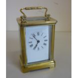 Small brass cased carriage clock with white enamel dial (12cm high)