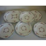 Set of five late 19th C continental dinner plates painted with floral detail, the underside marked