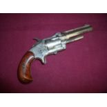 Derringe .32 rim fire revolver with 3 1/2 inch barrel engraved to the top and sides with two piece