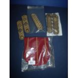 Busby bag with red backing & yellow pipe work and a selection of officers gilt braided epaulettes