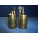 Two similar brass lighters, one stamped Evva Patent W.F Austria (7cm high)