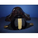 Naval officers bicorn hat with gilt braided mounts at fore and aft peaks with central braid and silk