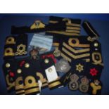 Large collection of naval insignia, mostly embroidered cloth, including epaulettes, cap tallies,