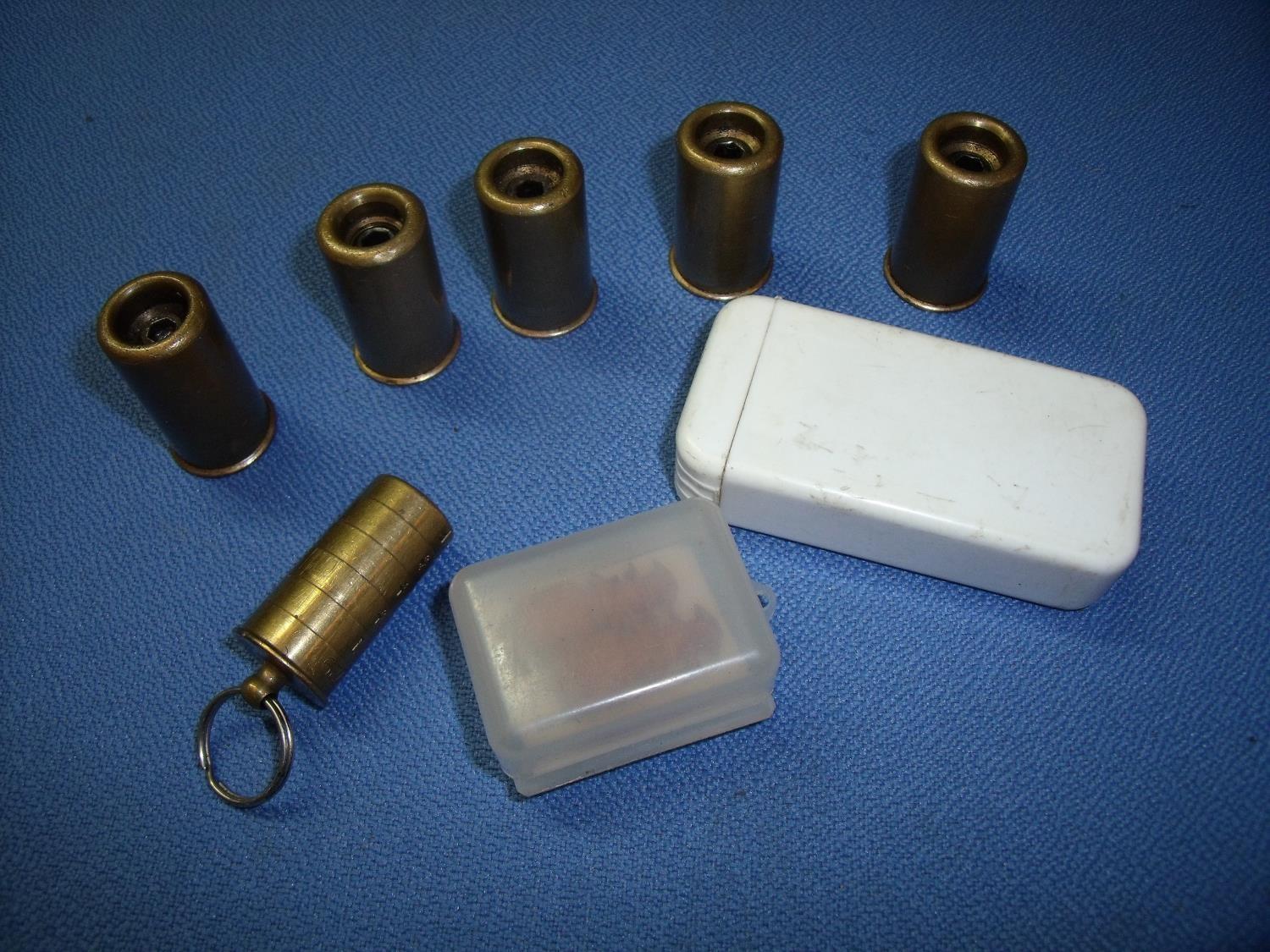 Two pairs of 12 bore brass snap caps another single 12 bore snap cap, choke gauge and ear plugs