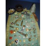 Selection of various cap badges, a Civil Defence Corp lapel badge, inert ammunition, various Russian