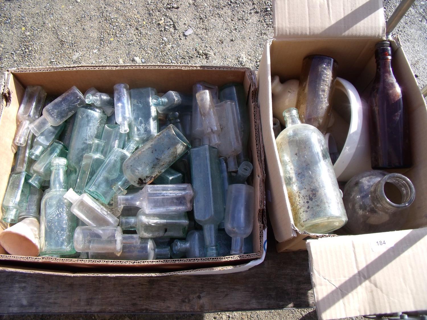Two boxes containing a large collection of Victorian and later mostly glass bottles, a Stoneware