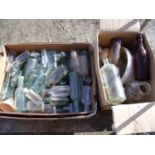 Two boxes containing a large collection of Victorian and later mostly glass bottles, a Stoneware