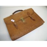 Tan leather satchel with brass lock