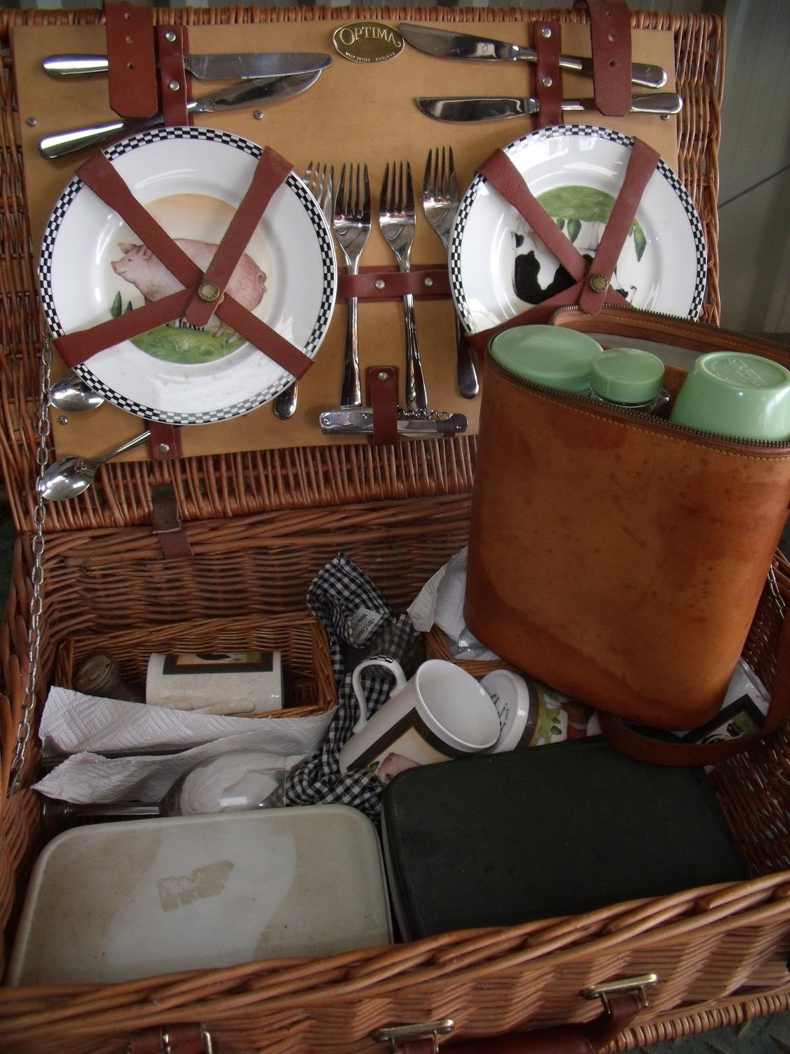 Wicker picnic basket with associated plates, crockery etc and a tan leather picnic carry case with