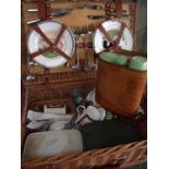 Wicker picnic basket with associated plates, crockery etc and a tan leather picnic carry case with