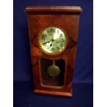 Early 20th C walnut cased wall clock with steel face and chiming movements enclosed by a glazed door