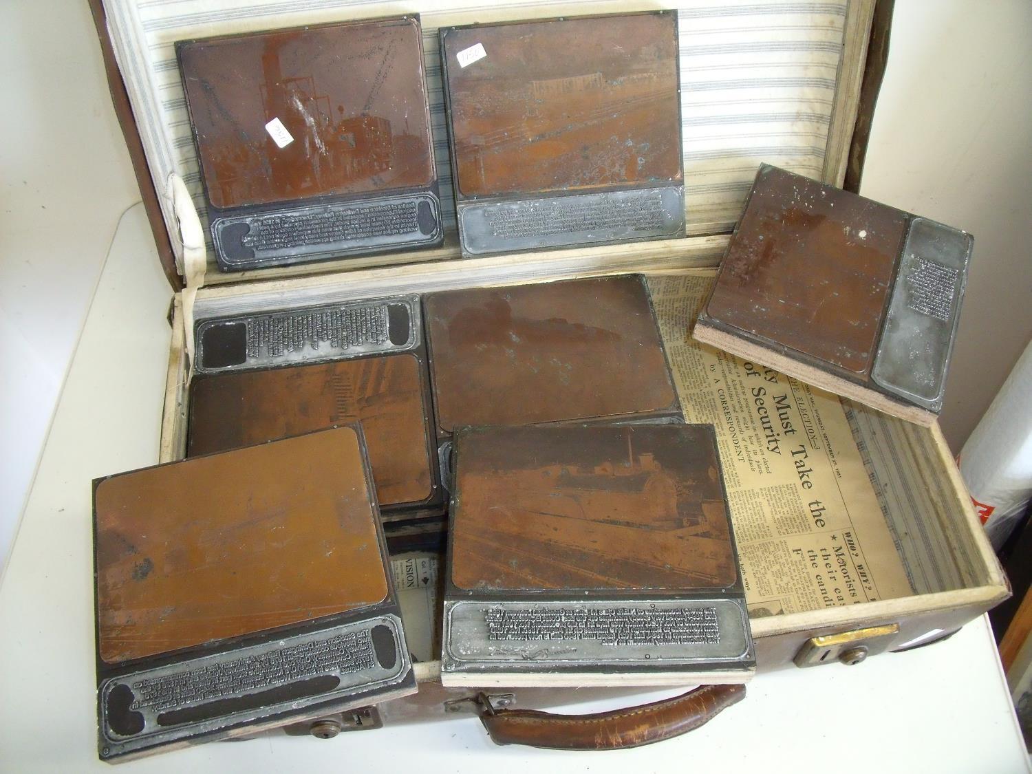 Vintage suitcase containing a selection of railway related items including various printing blocks