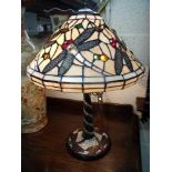 Tiffany style dragonfly table lamp with coloured glass shade emblazoned with figures of