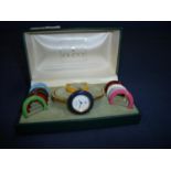 Cased Gucci ladies wristwatch with gold coloured bracelet strap with interchangeable coloured bezel,
