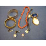 Sterling silver bracelet in the form of a belt, a gilt metal hinged bracelet, coral necklace,