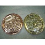 Pair of early 20th C Arts & Crafts style circular chargers with embossed detail, one copper and