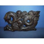 17th/18th C carved oak panel depicting winged cherub riding a fish-tailed horse upon the waves (39cm