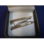 Two 9ct gold tie clips with chains, with makers marks front and back N.G & G