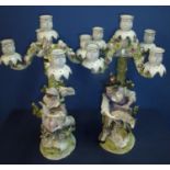 Pair of 19th C continental ceramic four branch candelabra depicting couple holding lambs sat upon