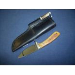 Sheffield made 2.5 inch skinning type knife with brass mounts, two piece grips and leather sheath,