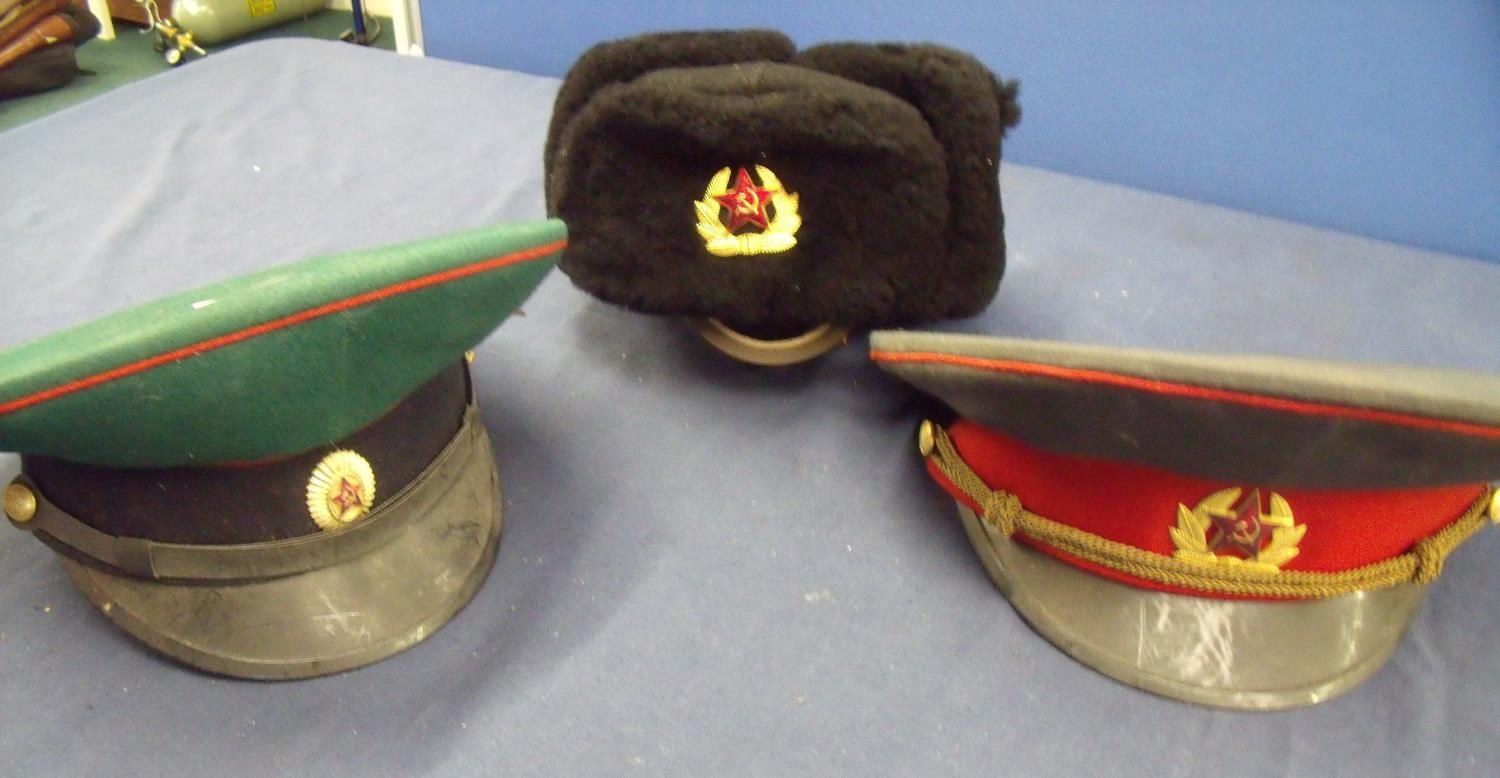 Three Russian military hats including green cap possibly intelligence service, winter hat and