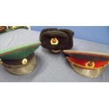 Three Russian military hats including green cap possibly intelligence service, winter hat and