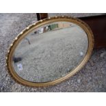 Gilt framed bevelled edge oval wall mirror (56cm x 45cm)