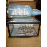 Glazed and cased display of model sailing ships (27cm x 19cm x 14cm) and a triple masted ship in