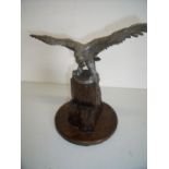 Large silver plated figure of an eagle with wings outstretched mounted on carved oak rocky