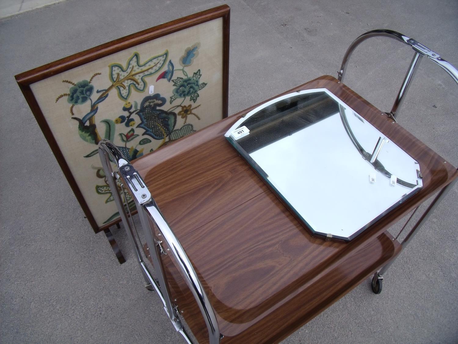 Chrome framed two tier folding tea trolley, a 1930s bevelled edge wall mirror and a embroidered fire