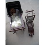 Wooden framed model of a Victorian style coach built pram with porcelain headed doll and another