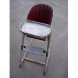 Circa 1960s metal framed child's highchair with padded back and seat