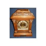 Carved walnut cased mantel clock, brass and steel face with brass presentation plaque, with striking