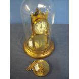 400 day brass clock with white enamel dial under glass dome (30cm high)