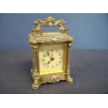 Silver plated repeating carriage type clock with ornate case, with floral detail and white enamel