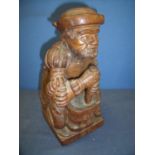 Carved oak figure of a alchemist/apothecarist kneeling at pestle and mortar (32cm high)