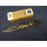 Boxed as new Elk Ridge pocket knife with 2 1/2 inch blackened blade and belt clip