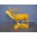 Large composite figure of a stag at call on kidney shaped stepped wooden base (height 32cm)