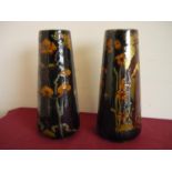 Pair of Art Nouveau ceramic vases of tapering form, depicting semi clad ladies (height 37cm)