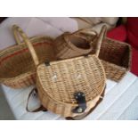 Four wicker baskets of various sizes, one of which is a picnic basket