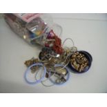 Tub containing a large selection of costume jewelry