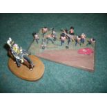 Cast metal scale model of a 13th Hussar on wooden base and a group painted cast metal model set of a