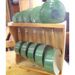 Set of five Le Creuset green enamel sauce pans complete with wall rack