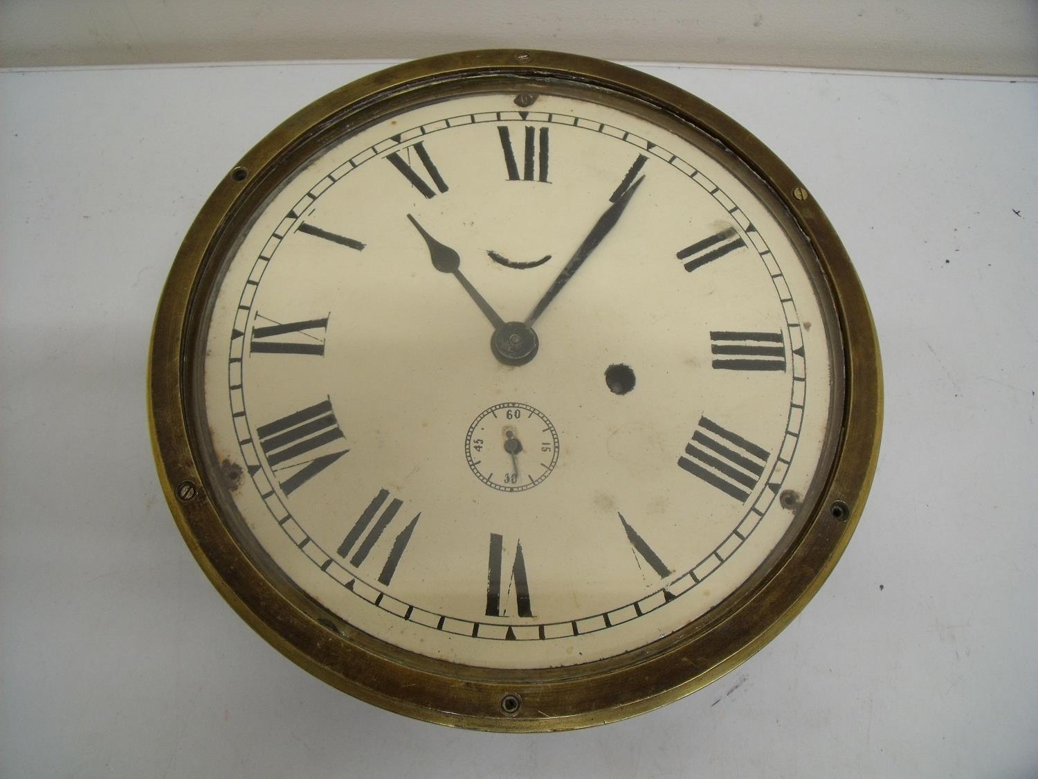 Brass cased bulkhead clock (diameter 24cm)