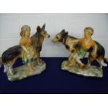 Pair of large mid 20th C painted plaster figures of a boy and a girl with Alsatians (approx. 42cm