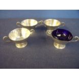 Set of four London 1912 silver hallmarked twin handled cups (height 3.5cm), one with blue glass