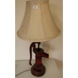 Decorative table lamp made from a cast metal water pump, complete with cream lampshade (height